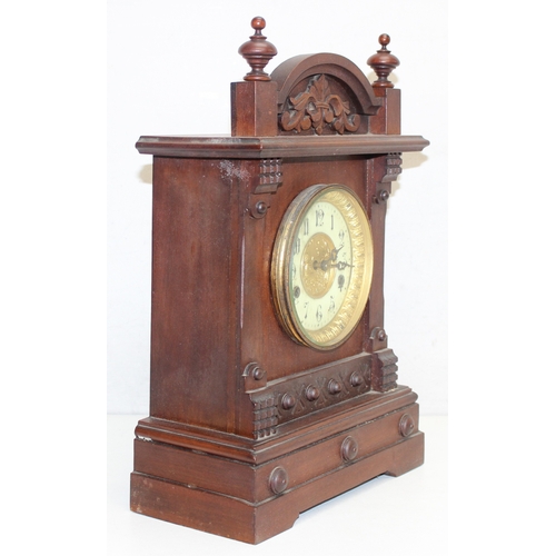 1368 - An early 20th century mahogany cased mantle clock with mechanical movement, key and pendulum, approx... 