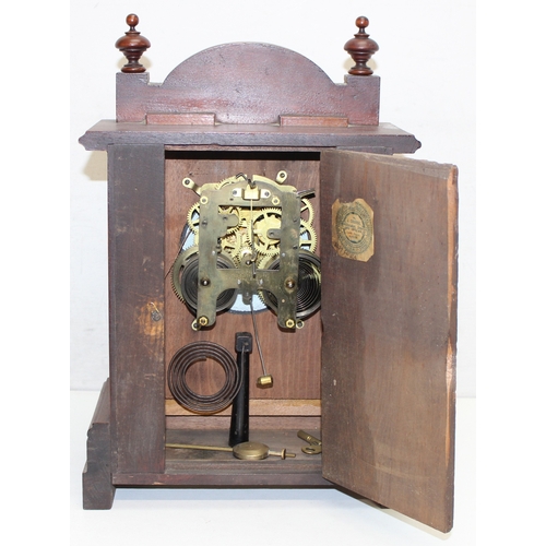 1368 - An early 20th century mahogany cased mantle clock with mechanical movement, key and pendulum, approx... 