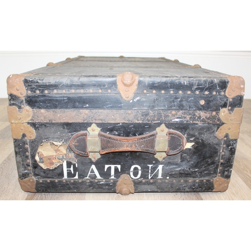 105 - 2 vintage black shipping trunks with metal bound corners, both without makers marks, the largest app... 