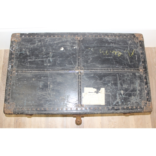 105 - 2 vintage black shipping trunks with metal bound corners, both without makers marks, the largest app... 