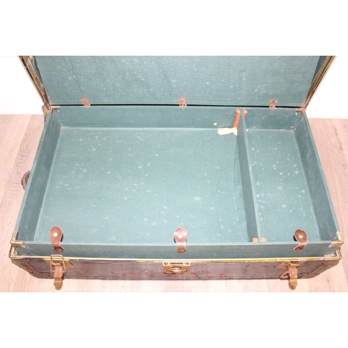 105 - 2 vintage black shipping trunks with metal bound corners, both without makers marks, the largest app... 