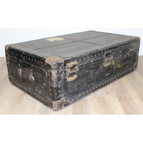 105 - 2 vintage black shipping trunks with metal bound corners, both without makers marks, the largest app... 