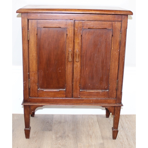 102 - A small antique mahogany side cabinet with 2 doors, standing on spade legs, the interior with single... 