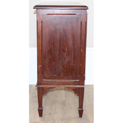 102 - A small antique mahogany side cabinet with 2 doors, standing on spade legs, the interior with single... 