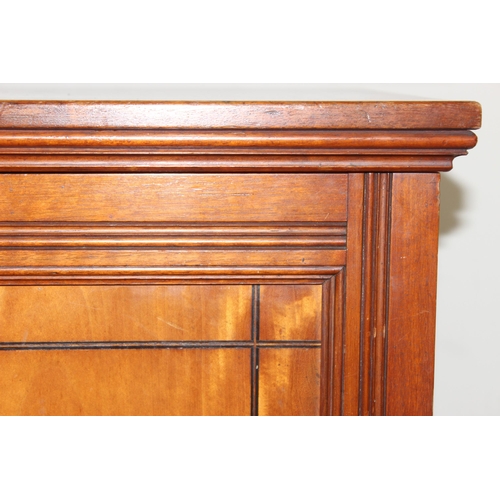 4 - Gillows of Lancaster, a vintage 2 door mahogany library cabinet or bookcase, the top of one door sta... 