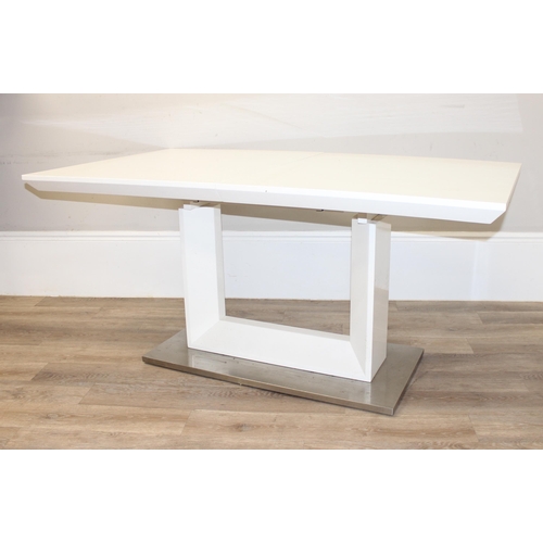 21 - A large modern white extending dining table with brushed steel base, seemingly unmarked, approx 160c... 