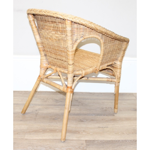 18 - A pair of wicker chairs and a large wicker laundry basket, each chair approx 60cm wide, the basket a... 