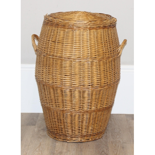 18 - A pair of wicker chairs and a large wicker laundry basket, each chair approx 60cm wide, the basket a... 