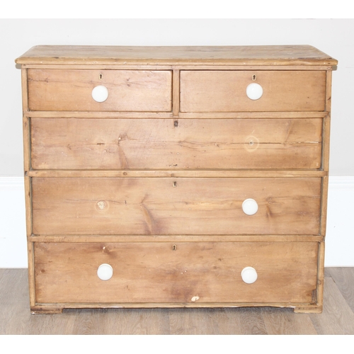 13 - An antique stripped pine 2 over 3 chest of drawers with partial ceramic bun handles, approx 100cm wi... 