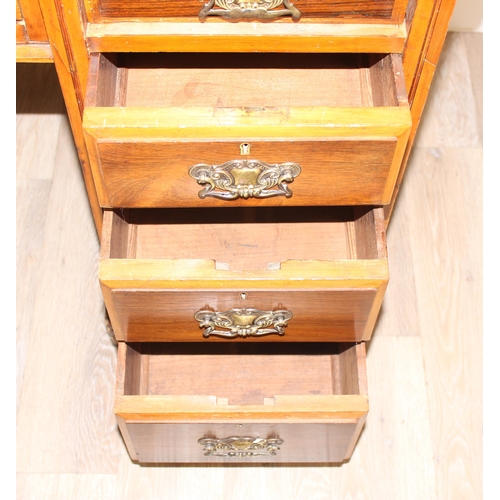 70 - A vintage kneehole desk with 9 drawers and brass handles, distressed leather inset top, approx 122cm... 