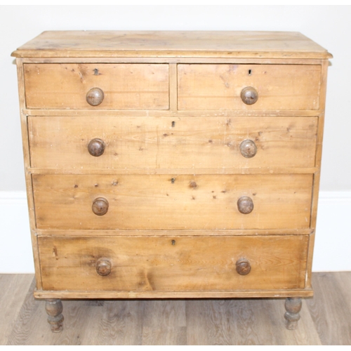 12 - A Victorian pine 2 over 3 chest of drawers with turned wooden handles and bun feet, approx 92cm wide... 