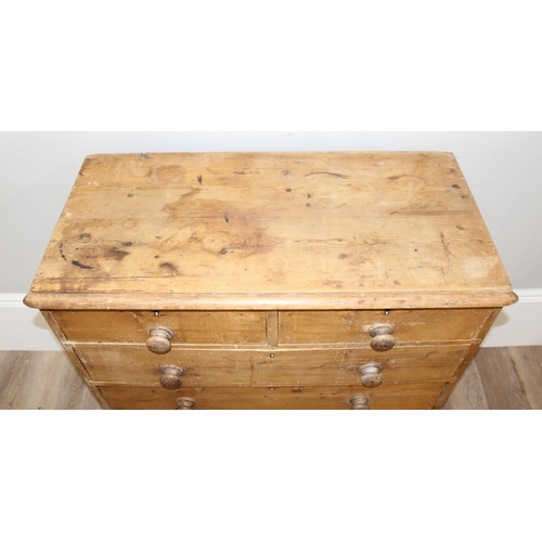 12 - A Victorian pine 2 over 3 chest of drawers with turned wooden handles and bun feet, approx 92cm wide... 