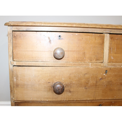 12 - A Victorian pine 2 over 3 chest of drawers with turned wooden handles and bun feet, approx 92cm wide... 