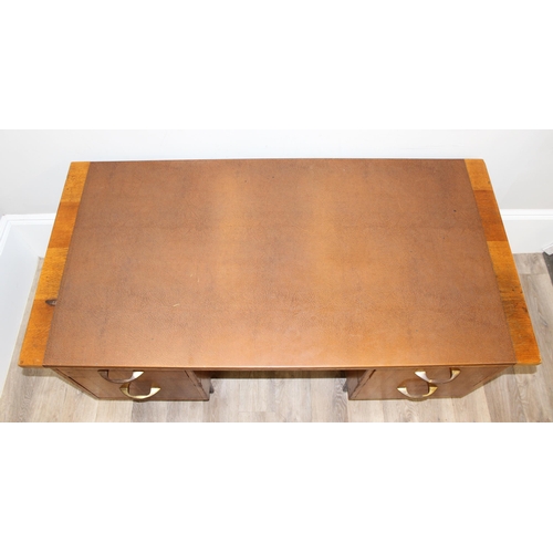 11 - A retro brown leather topped oak desk by Durant office furniture, approx 153cm wide x 76cm deep x 73... 