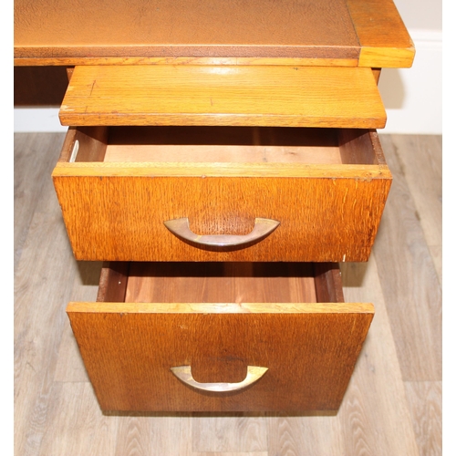 11 - A retro brown leather topped oak desk by Durant office furniture, approx 153cm wide x 76cm deep x 73... 