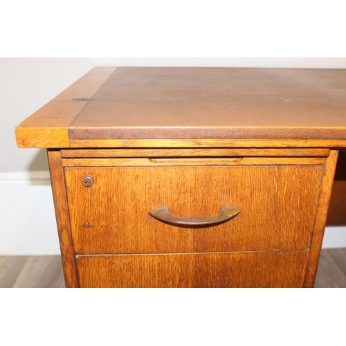 11 - A retro brown leather topped oak desk by Durant office furniture, approx 153cm wide x 76cm deep x 73... 