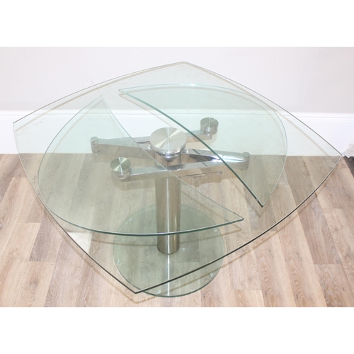 15 - A retro style extending glass table with chrome base and unusual mechanism, seemingly unmarked, appr... 