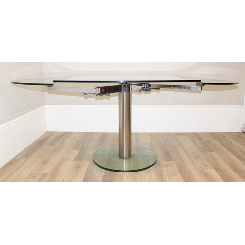 15 - A retro style extending glass table with chrome base and unusual mechanism, seemingly unmarked, appr... 