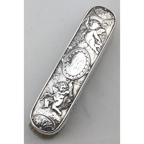 1113 - A superb quality silver backed hand mirror embossed with scenes of cherubs, marked for Birmingham 18... 