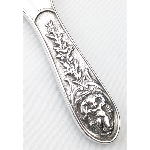 1113 - A superb quality silver backed hand mirror embossed with scenes of cherubs, marked for Birmingham 18... 