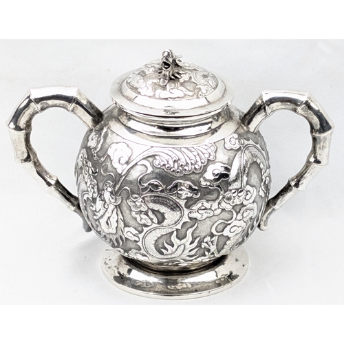 1123 - An impressive Chinese export silver sugar bowl with lid, embossed dragon design with a dragon head f... 