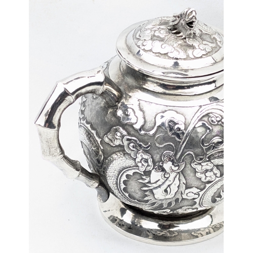 1123 - An impressive Chinese export silver sugar bowl with lid, embossed dragon design with a dragon head f... 