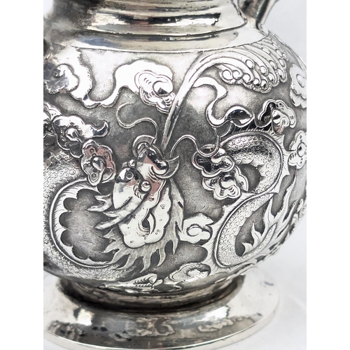 1123 - An impressive Chinese export silver sugar bowl with lid, embossed dragon design with a dragon head f... 