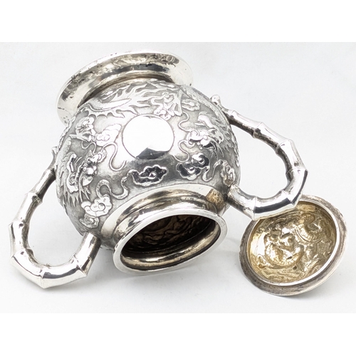 1123 - An impressive Chinese export silver sugar bowl with lid, embossed dragon design with a dragon head f... 