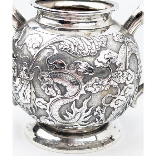 1123 - An impressive Chinese export silver sugar bowl with lid, embossed dragon design with a dragon head f... 