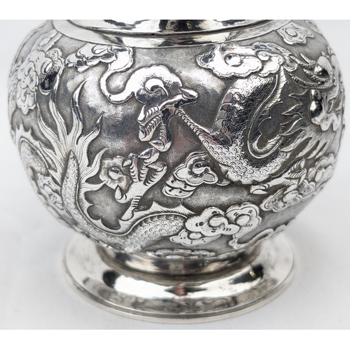 1124 - An impressive Chinese export silver cream or milk jug, embossed dragon design with bamboo effect han... 