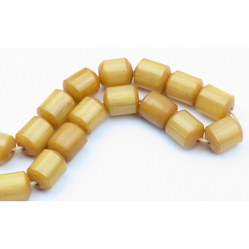 1151 - A vintage amber coloured cylindrical bead necklace, each bead approx 12mm wide, approx 30.49g gross