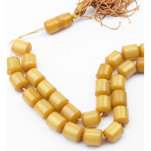 1151 - A vintage amber coloured cylindrical bead necklace, each bead approx 12mm wide, approx 30.49g gross