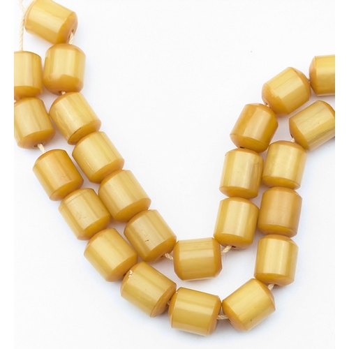 1151 - A vintage amber coloured cylindrical bead necklace, each bead approx 12mm wide, approx 30.49g gross