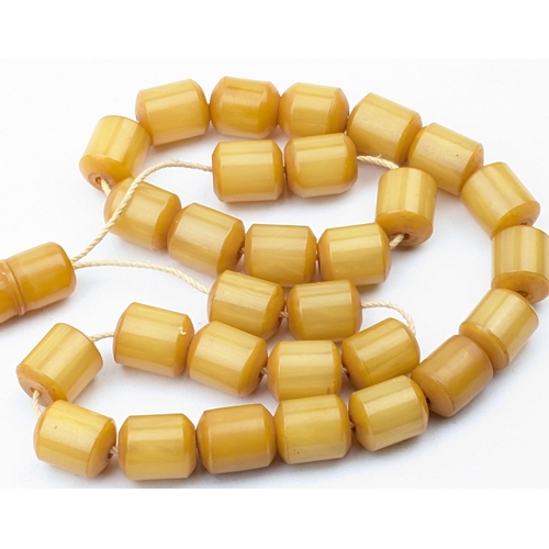 1151 - A vintage amber coloured cylindrical bead necklace, each bead approx 12mm wide, approx 30.49g gross