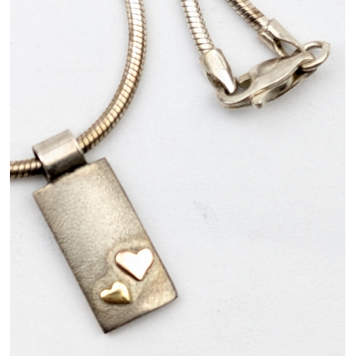 1180 - A retro silver dumbbell link silver necklace, a further silver necklace with 9ct gold heart mounting... 