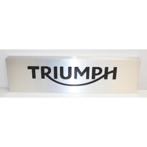 416 - Silver coloured metal Triumph Motorcycle wall display sign with polished black acrylic lettering, ap... 