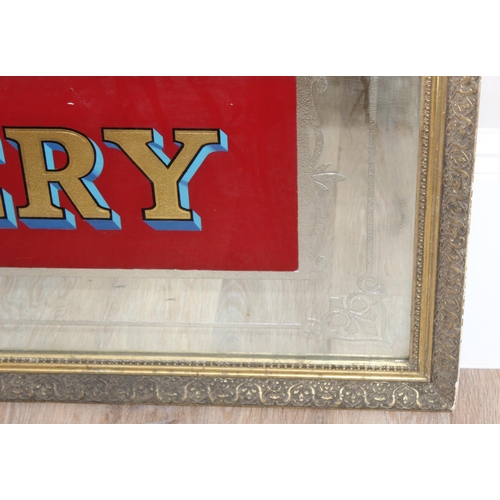 352 - A very large vintage mirror emblazoned with 