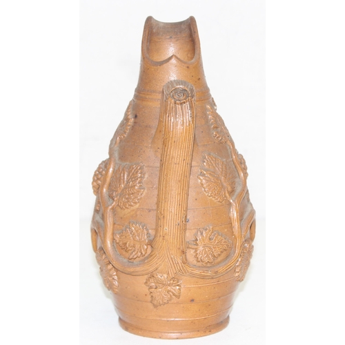 1505 - A superb quality 19th century stoneware jug with bacchanalian vine moulded relief design, believed t... 