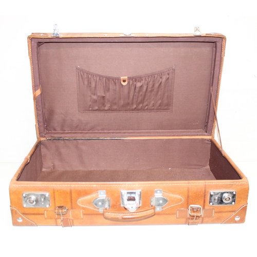 299C - A vintage leather suitcase with chrome plated fittings and various straps, seemingly unbranded, appr... 