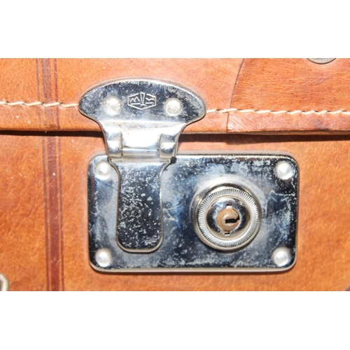 299C - A vintage leather suitcase with chrome plated fittings and various straps, seemingly unbranded, appr... 