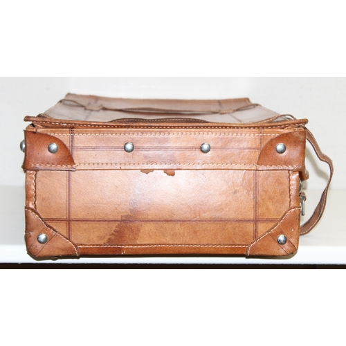 299C - A vintage leather suitcase with chrome plated fittings and various straps, seemingly unbranded, appr... 