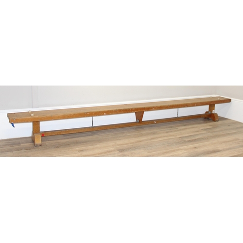 20 - A long vintage low wooden school gymnastics bench, approx 336cm long