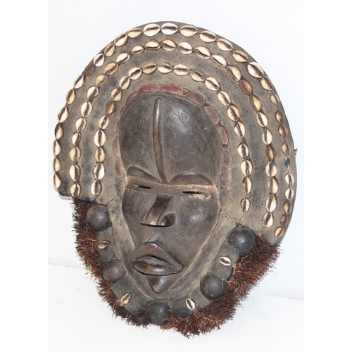 1529 - A vintage carved African mask with raffia beard and shells, believed to be a Congolese Lele mask, ap... 