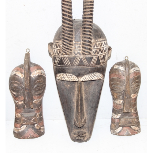 1530 - 5 assorted African masks with painted details, possibly Senegalese, the largest approx 44cm tall