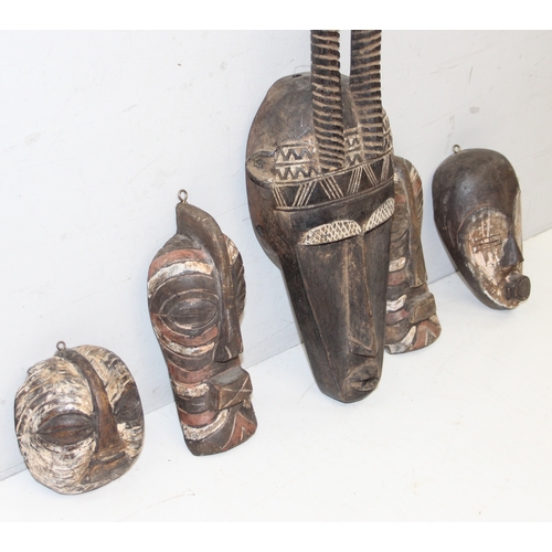 1530 - 5 assorted African masks with painted details, possibly Senegalese, the largest approx 44cm tall