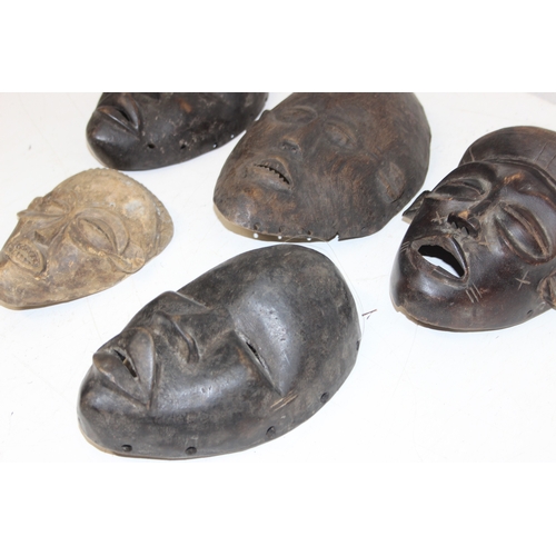 1531 - A group of 5 assorted African carved wooden masks, unknown age or origin, the largest approx 24cm ta... 