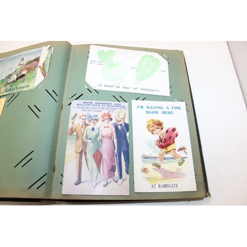 576 - An antique postcard album and contents to inc many early 20th century humorous cards