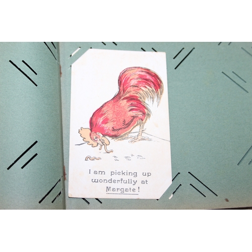 576 - An antique postcard album and contents to inc many early 20th century humorous cards