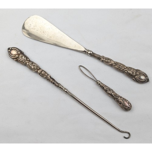 1111 - A boxed silver handled shoe horn and button hook set, marks rubbed but one visible for Chester 1898,... 