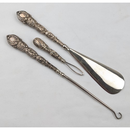 1111 - A boxed silver handled shoe horn and button hook set, marks rubbed but one visible for Chester 1898,... 